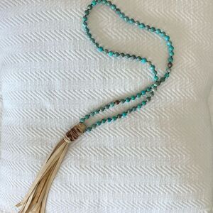 long vibrant clay bead  necklace with leather fringe 29 inch in length